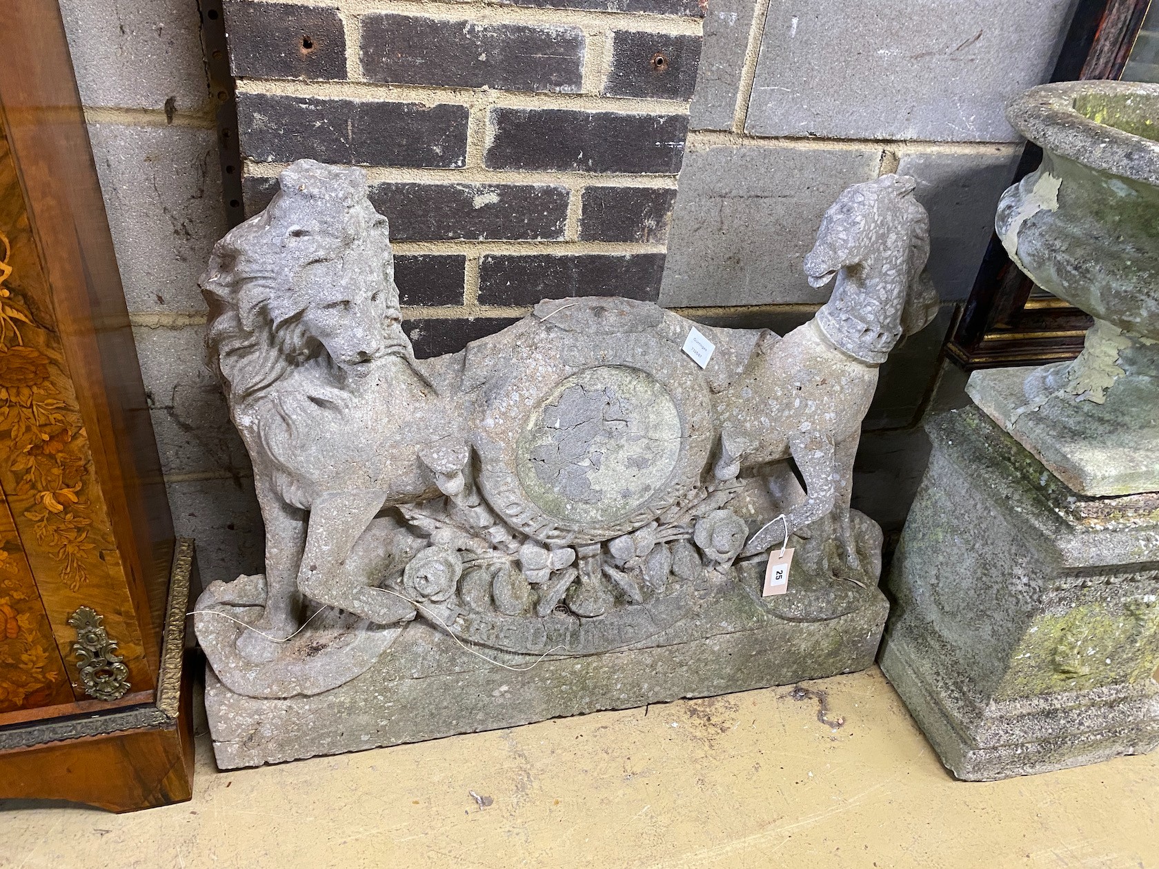 A reconstituted stone Royal Coat of Arms (incomplete), width 90cm, height 72cm